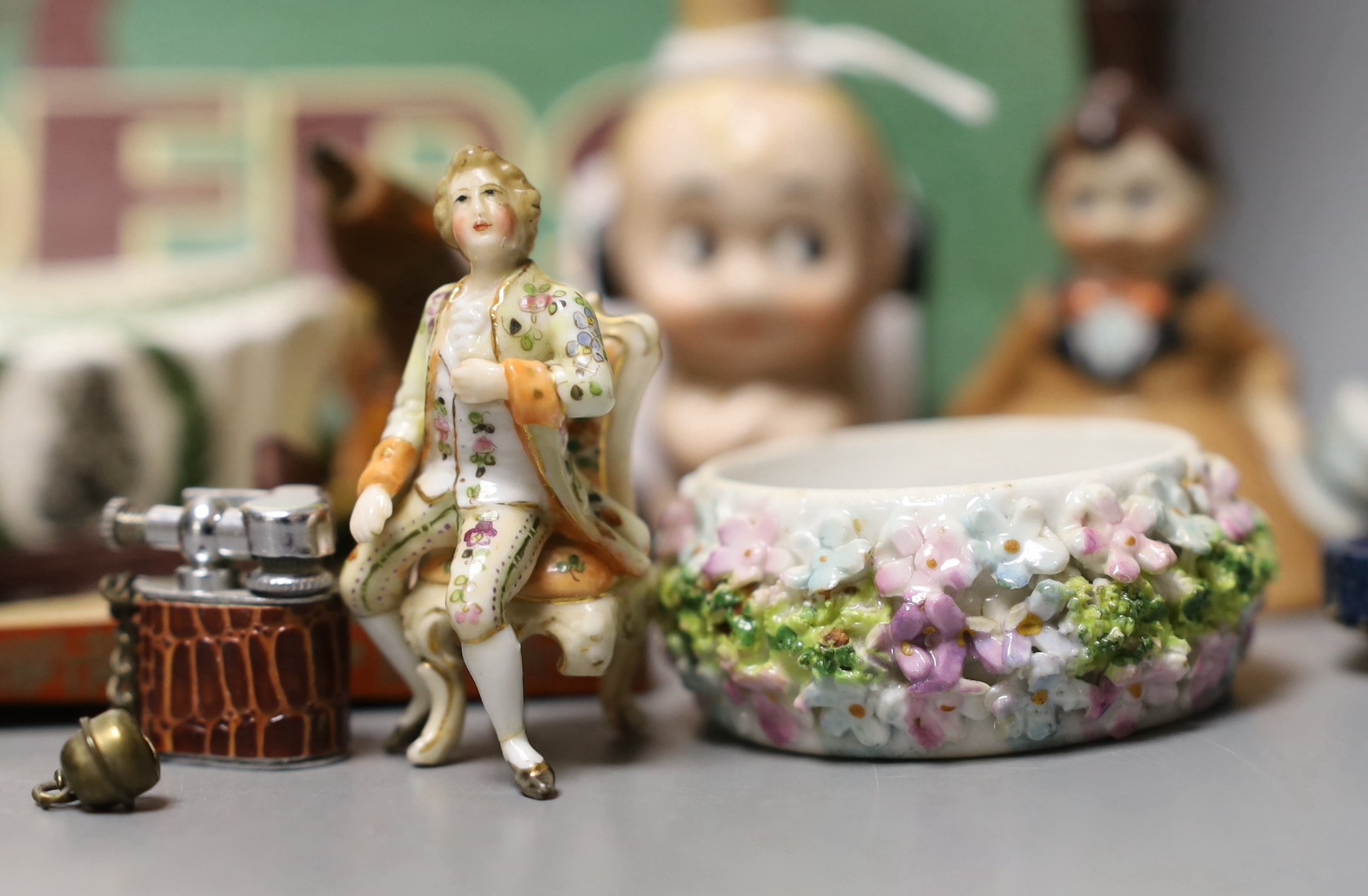 A group of collectables including a Boer War horn cup, a 1930's Betty Boop ceramic scent bottle, a commemorative Wedgwood Nelson jug, etc.